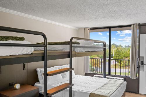a bedroom with two bunk beds and a window at Branson Falls Lodge in Branson