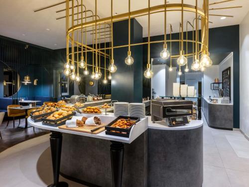 a buffet with many different types of food on a table at Pullman Stuttgart Fontana in Stuttgart