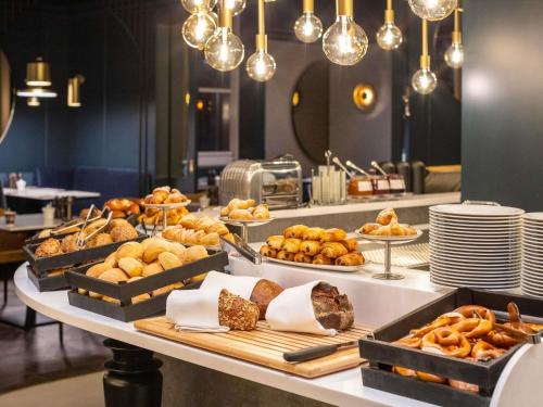 a buffet with many different types of bread and pastries at Pullman Stuttgart Fontana in Stuttgart