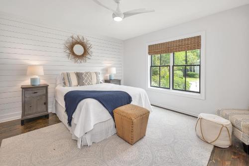 a white bedroom with a bed and a window at 225 Olive Way in East End