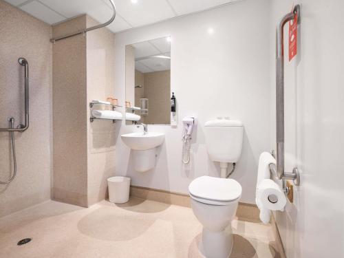 a bathroom with a toilet and a sink at ibis Rotorua in Rotorua