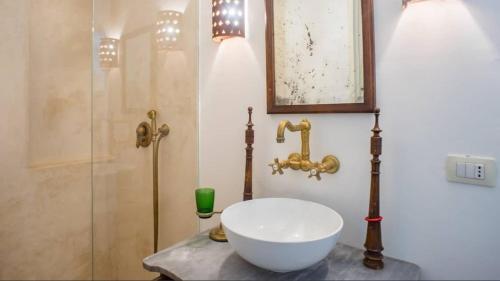 a bathroom with a sink and a shower at Villa Charita - Old Masseria in the historical town with private pool in Castrignano del Capo