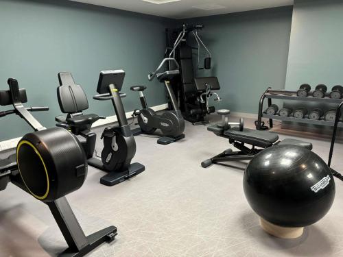 a gym with a bunch of exercise equipment in a room at Mercure Caen Cote De Nacre in Caen