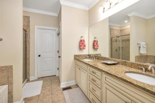 a bathroom with a double sink and a shower at 903 Reserve Lane in Jewtown