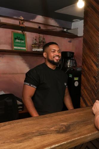 a man sitting at a counter in a coffee shop at Kim in Cartagena de Indias