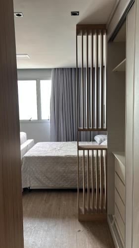 a bedroom with a bed with a crib in it at Apto 2306 in Santos