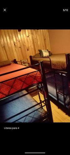 a room with two bunk beds in a room at El Manik cabañas El Tlayan in Tala