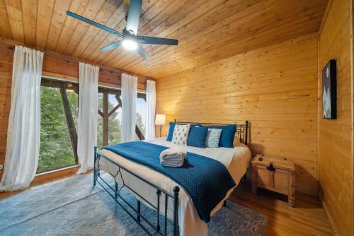 a bedroom with a bed and a ceiling fan at Carolina Lookout in Boone