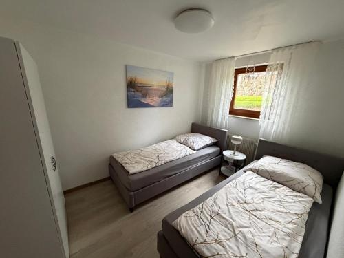 a bedroom with two beds and a window at Apartment HESS in Rust