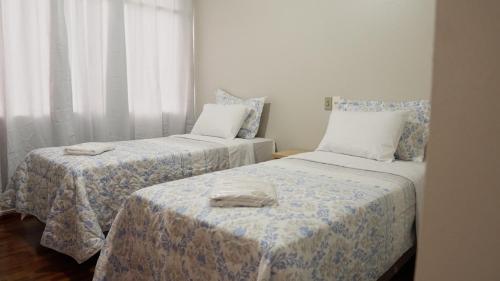 a room with two beds with towels on them at Hotel LF by Feliciano Joaçaba in Joaçaba