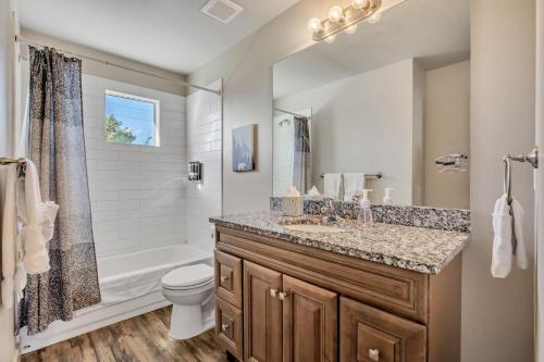 a bathroom with a sink and a toilet and a shower at Hill Field Stays by Cloud Dream Homes in Layton