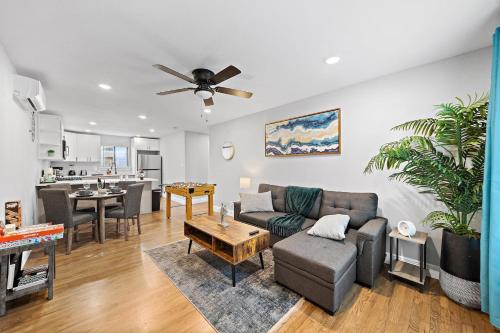 a living room with a couch and a table at Nr Museum Med Center Zoo Apt Fire Pit BBQ Games in Houston