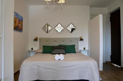 a bedroom with a bed with two white shoes on it at Estudio Finca Mas el Bravo in Caudiel