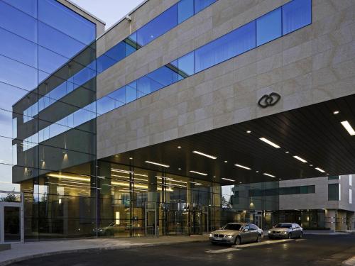 two cars parked in front of a building at Sofitel London Heathrow in Hillingdon