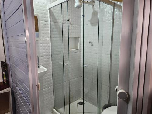 a bathroom with a shower with a toilet and a sink at Pousadinha Copacabana in Rio de Janeiro