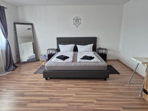 a bedroom with a bed and a large mirror at Domspitze in Schwerin