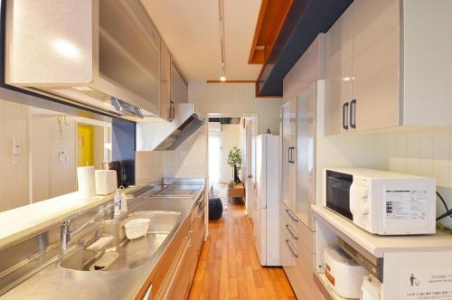 a kitchen with a sink and a refrigerator at I will meet Hyakuna, - Vacation STAY 33599v in Nanjo