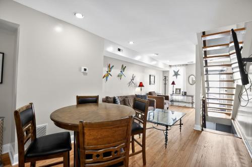 a dining room and living room with a table and chairs at Canton townhome in Baltimore