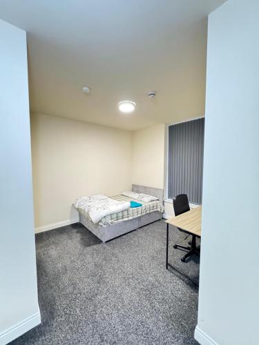 a room with a bed and a desk in it at Barnsley Guesthouse Couple Room Ground Floor in Barnsley