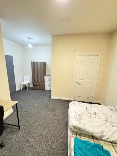 a room with two beds and a door at Barnsley Guesthouse Couple Room Ground Floor in Barnsley