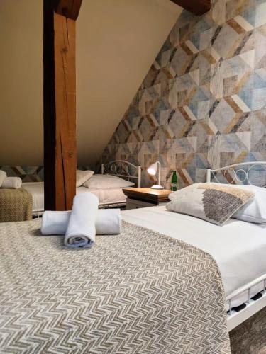 a bedroom with two beds and a stone wall at AmaMolto Train Station in Opole