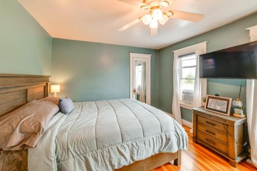 a bedroom with a bed and a flat screen tv at 1 Mi to Dtwn Binghamton Pet-Friendly Home with Deck in Binghamton