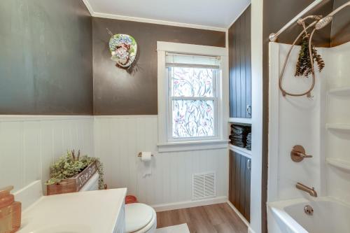 a bathroom with a toilet and a window at 1 Mi to Dtwn Binghamton Pet-Friendly Home with Deck in Binghamton