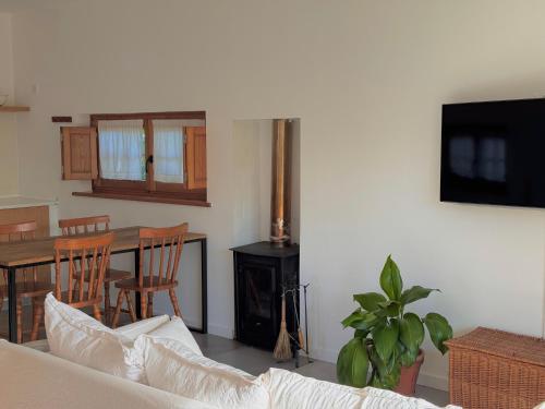 a living room with a couch and a table and a fireplace at Quinta Amarela - B&B in Nazaré
