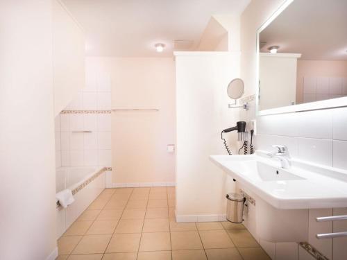 un bagno bianco con lavandino e doccia di Manslagt - Greetsiel a Greetsiel