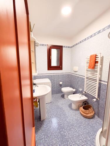 a blue and white bathroom with a toilet and a sink at Dimora Lucci Marini in Taranto