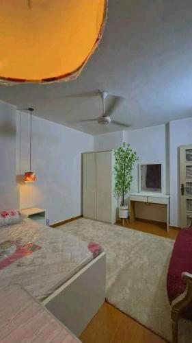 a living room with a bed and a tv at Vrtn hotel in Amman