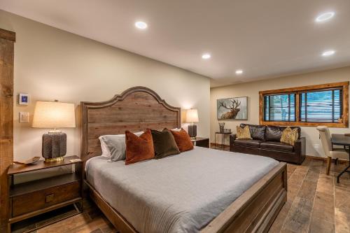 a bedroom with a large bed and a couch at Moosey Creek Lodge in Banner Elk