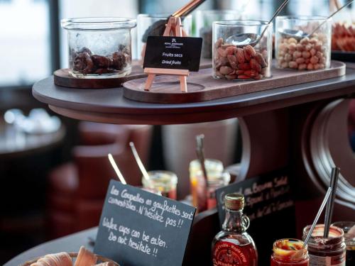 a display of food on a shelf in a store at Royal Emeraude Hotel Dinard - MGallery Collection in Dinard