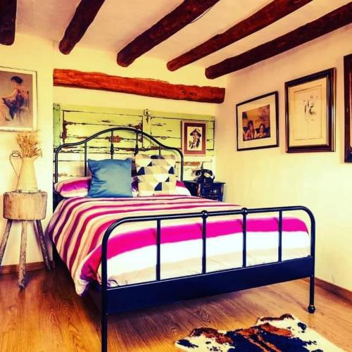 a bedroom with a bed with a metal frame at Casa Cosialls in Benabarre