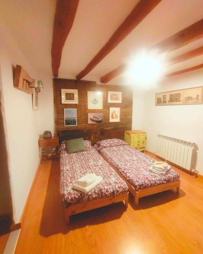 a bedroom with two beds in a room at Casa Cosialls in Benabarre