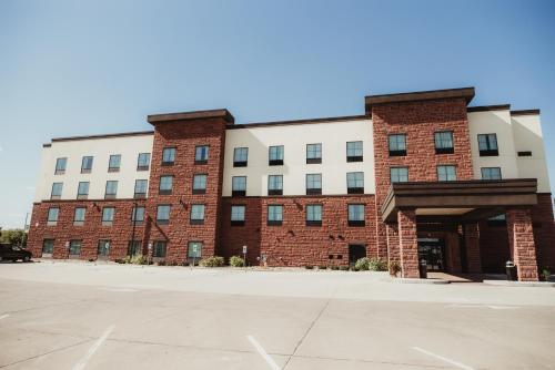 OttumwaにあるCobblestone Hotel & Suites - Ottumwaのレンガ造りの建物の前の空の駐車場