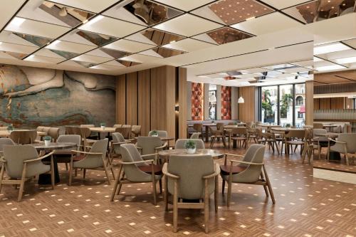 a dining room with tables and chairs at Delta Hotels by Marriott Istanbul Karakoy in Istanbul