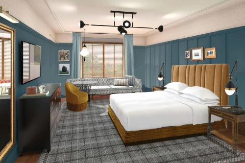 a bedroom with a bed and a living room at The Union Hotel, Flemington, a Tribute Portfolio Hotel in Flemington