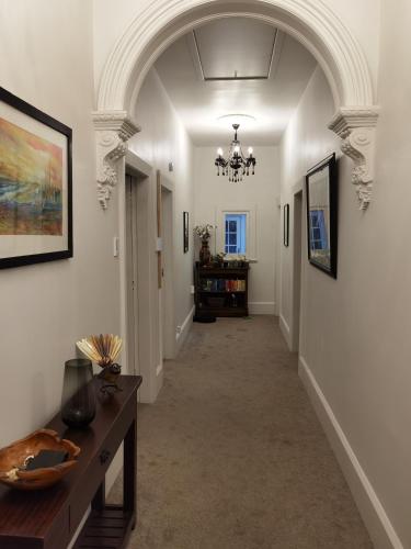 a hallway with an archway in a building at Beautiful villa near everything! in Christchurch
