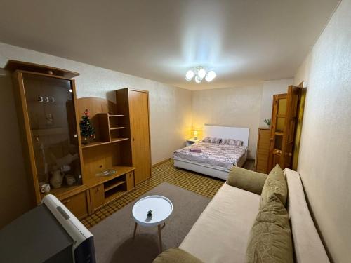 a living room with a couch and a bed at Суворова-Титова in Dnipro