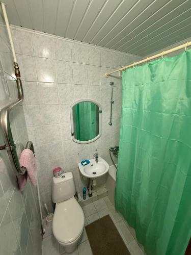 a bathroom with a toilet and a sink and a shower at Суворова-Титова in Dnipro