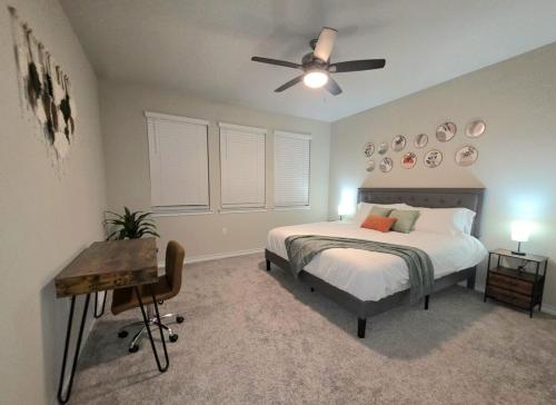 a bedroom with a bed and a ceiling fan at Austin House w Pool! by Airport, Tesla, and more! in Austin