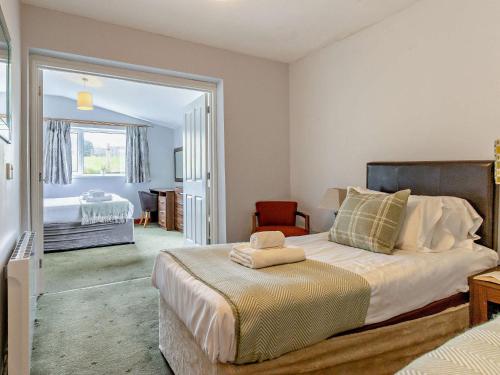 a bedroom with a large bed in a room at 5 Bed in Aberystwyth 95994 in Llanfihangel-geneuʼr-glyn