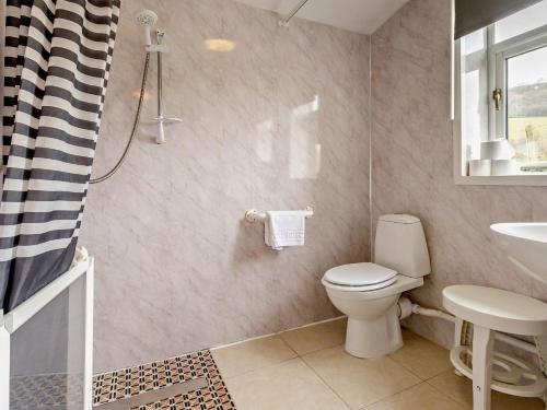 a bathroom with a toilet and a sink at 5 Bed in Aberystwyth 95994 in Llanfihangel-geneuʼr-glyn