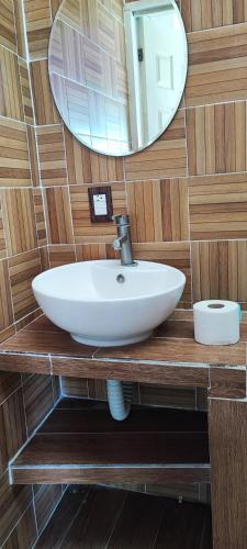 a bathroom with a sink and a mirror at Blessed Rest Home Teques in Tequesquitengo