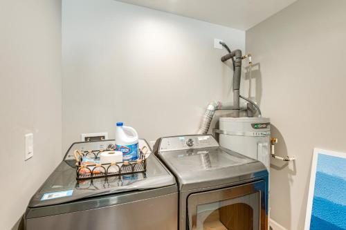 a kitchen with a sink and a washing machine at Hot Tub and Game Room Luxe Cabin, Day Trip to Tahoe in Pollock Pines