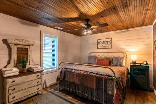 a bedroom with a bed and a wooden ceiling at Up the Creek in Linville