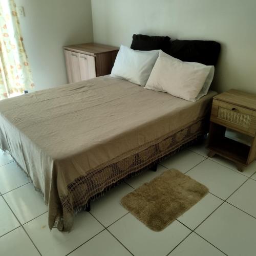 1 cama con 2 almohadas y 1 mesa en una habitación en Sobrado vista mar Piçarras, en Piçarras