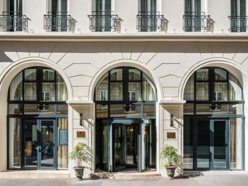 a facade of a building with large windows at Hotel Faubourg Galant Paris - Handwritten Collection in Paris
