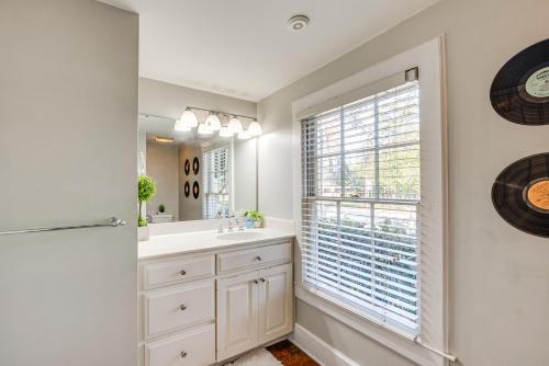 a bathroom with a sink and a window at Walk to Dtwn Hahira Inviting Home with Pool and Yard! in Hahira
